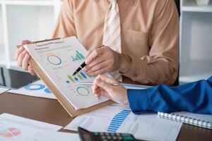 Accountants reviewing monthly budget metrics and performance charts in a sleek office photo