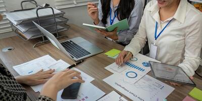 Diverse team analyzing data charts and discussing strategies during a focused business meeting in a modern office photo