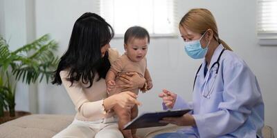 Parent and doctor discussing baby health during a pediatric consultation photo