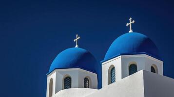 Blue domes of Oia Santorinis iconic churchscape against the sky photo