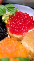 sandwiches with Rick caviar pike caviar sturgeon and salmon croquettes add lemon to sandwich garnish with lemon and herbs red caviar. appetizer with red caviar video