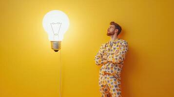 Modern Man Illuminating Bright Ideas in Stylish Pajamas photo