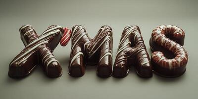 Delicious chocolate letters shaped like Xmas decorations on a neutral background photo