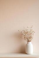 A matte ceramic vase filled with dried wildflowers sits on a light wooden shelf against a muted beige background, creating an elegant and eco-friendly decor setup perfect for any space photo