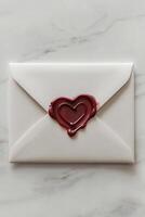 This classy envelope features a red wax seal shaped like a heart, set against a simple white background. Ideal for love letters, invitations, or special notes, it exudes sophistication photo