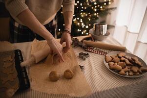 The table is filled with gingerbread dough, and festive cookie cutters are lined up for shaping. photo