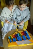 The boy and girl smile as they play their instruments. photo