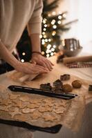 The kitchen counter is filled with gingerbread dough and Christmas-themed cookie cutters for baking. photo