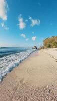 Walking first view person on tropical beach with ocean on sunny day. Vertical footage video