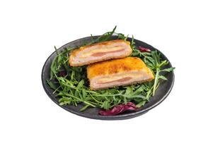 Fried Cordon bleu escalopes with salad on plate isolated on white background. top view photo