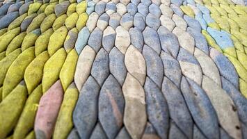 A close up of a colorful rug made of different colored yarns photo