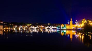 Panoramic view of Prague at night with the Charles Bridge and Prague Castle illuminated photo