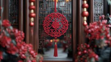 An intricate red knot decoration hangs elegantly against a wooden lattice backdrop, surrounded by festive accents, symbolizing unity, prosperity, and tradition during Chinese New Year celebrations. photo