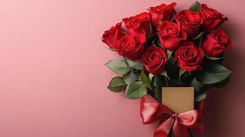 A vibrant bouquet of red roses tied with a silky red ribbon and accompanied by a blank gold card rests against a soft pink background, embodying elegance, love, and thoughtful gifting. photo