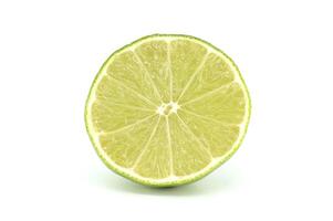 Fresh lime cut in half showing its texture and segments on white background photo