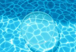 Top view of an empty clear glass round podium on blue transparent water with waves in sunlight, Cosmetic or beauty product presentation, copy space, Summer products ideas photo