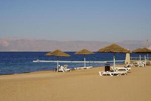 Relax on the beach with umbrellas and sun loungers photo