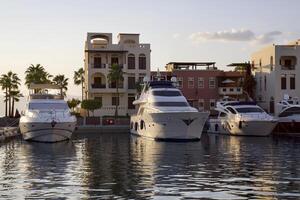 Yachts at the pier in the rays of sunset in Aqaba, Jordan. photo