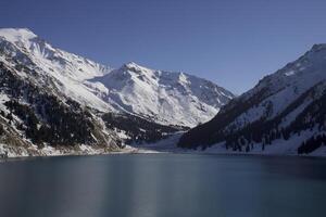 Winter mountain lake surrounded by a mountain rage photo