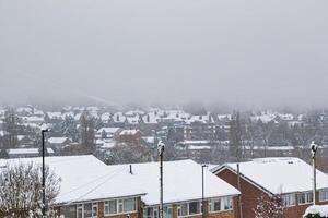 Snow-Covered Suburban Housing Development Under Overcast Sky in Harrogate, UK. photo