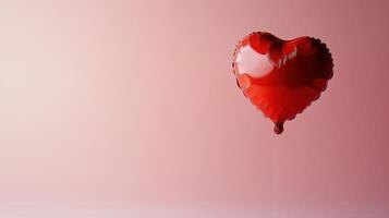 A Beautiful Red Heart-Shaped Balloon Floating Gracefully Against a Soft Pink Background, Evoking Feelings of Love and Joy for Any Occasion photo