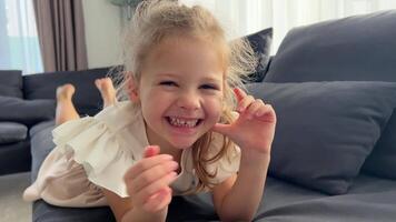 Llittle girl having fun looking at camera in home. High quality 4k footage video
