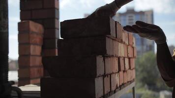 Worker stacking bricks in a neat pile video