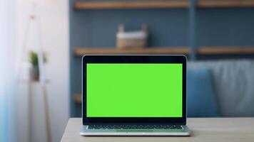 Laptop with blank empty screen on table. The modern workspace is calm with natural light, indicating a moment of personal enjoyment or productivity. video