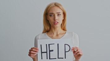 A young woman stands with her head bowed, exhibiting feelings of sadness and vulnerability. The focus is on her emotional distress in a domestic environment, highlighting struggles with abuse. video