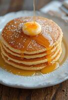 Stack of Pancakes with Butter and Maple Syrup photo