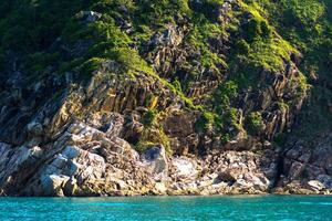 A tiered cliff on a tropical island with a blue sea on a clear day. photo