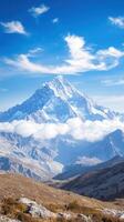 Majestic mountain peak towering above clouds in clear sky photo