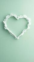 delicate lace doily shaped like heart on soft green background photo