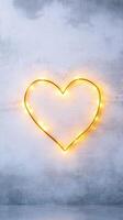 glowing gold heart shape made of lights on textured background photo