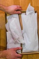 Packed sea food in a Cardboard Box on a Wooden Table. High quality photo