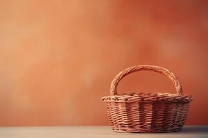 A wicker basket on a table against a red background photo