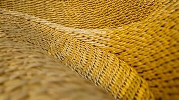 Abstract wave background with a braided wheat straw texture effect, showcasing golden yellow intertwined strands in a natural, flowing pattern, rendered in 3d video