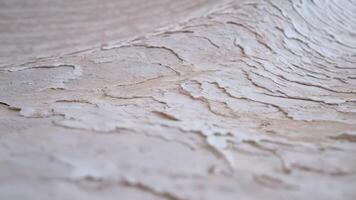 Elegant abstract wave background with a peeling paint texture effect, featuring weathered white and soft grey tones, rendered in 3d video
