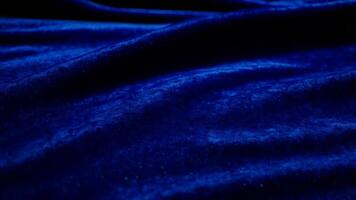Abstract flowing wave with soft velvet fabric texture, featuring deep royal blue tones and a subtle sheen for a luxurious, elegant effect video