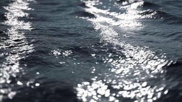 Shimmering abstract wave surface with metallic texture in liquid silver tones, reflecting light in a dynamic and elegant pattern video