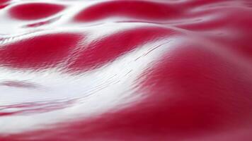 Abstract flowing wave with smooth jelly-like texture, featuring translucent raspberry red tones for a glossy, vibrant effect video