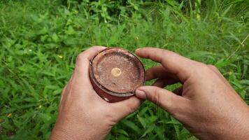 A person's hand tries to open a rusty paint can video