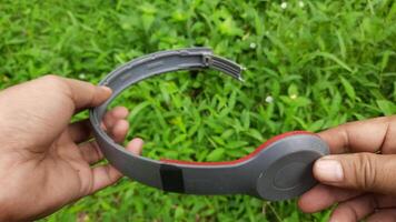 A man found a broken headset gadget in a green grass area video
