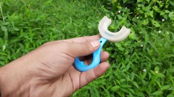 A person tests the elasticity of a baby silicone teether, a toy designed to soothe gums during teething video