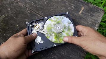 Exploring the inside of a hard drive in an outdoor setting with hands-on disassembly video