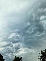 The sky turns menacing as storm clouds converge before a thunderstorm. photo
