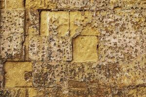The patina of time on a stone wall in Maltas historic alleyways. photo