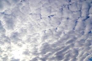The carefree atmosphere of summer captured in a sky full of bright clouds. photo
