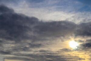 The summer sky glows with soft clouds floating in the sunlight. photo