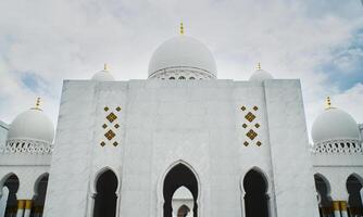 Elegant Sheikh Zayed Grand Mosque White Dome of a Marble Building Against a Vibrant Sky photo